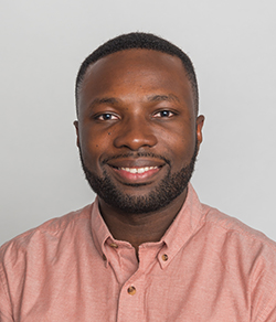 A close-up shot of Victor Adeyera, one of the podcast hosts, smiling gently at the camera.